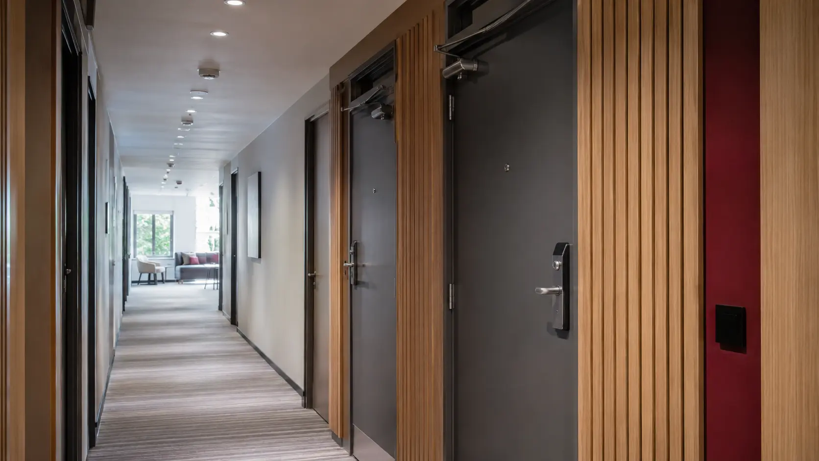 Modern university student-accommodation corridor with secure bedroom fire doors